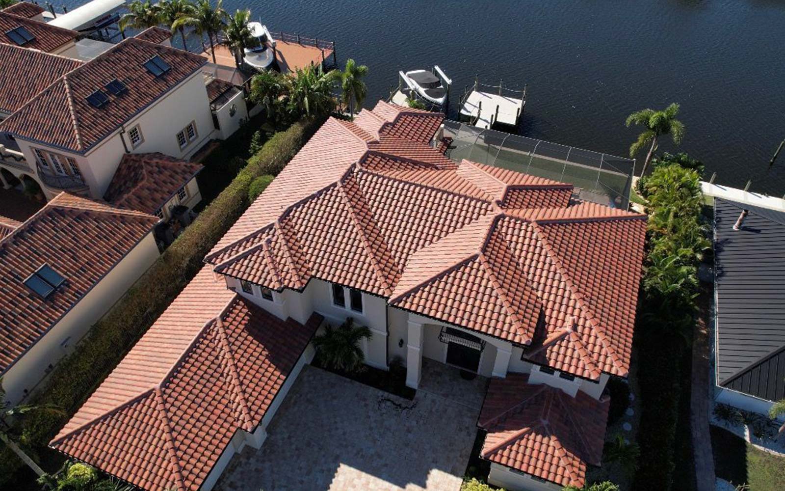 Curved reddish clay roof tiles with visible texture and slope