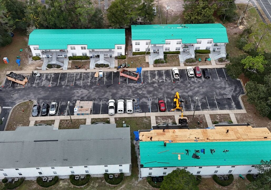 Aerial view of an apartment complex getting their roof redone